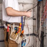 An electrician grouping wires together