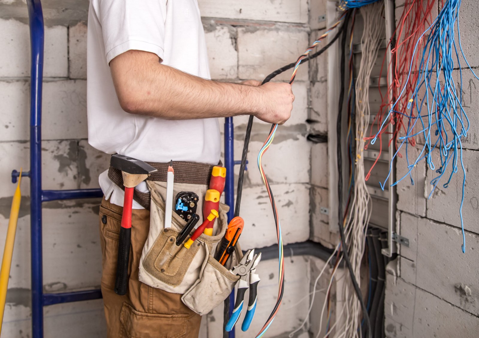 An electrician grouping wires together