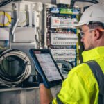 A professional reviewing the accuracy of a report on a tablet for certification and tendering documentation